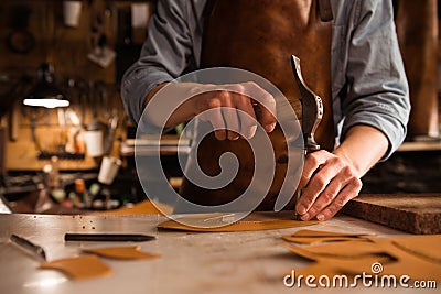 Close up of a shoemaker man working with leather Stock Photo