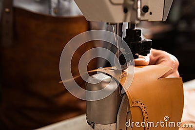Close up of a shoemaker using sewing machine Stock Photo