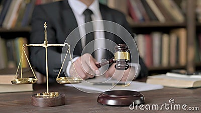 Close up Shoot of Judge Hand Banging the Gavel in Court Room Stock Photo