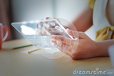 Close up shot Asian woman using clear tablet for futuristic cyber technology concept with HUD GUI User interface element hallow d Stock Photo