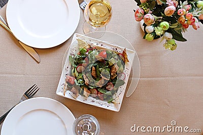 Close-up shot of a bowl of Fattoush salad, with a variety of colorful ingredients in a restaurant Stock Photo