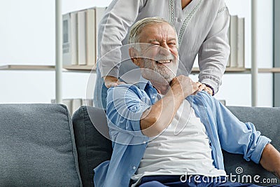 Close up shot of Caucasian old senior elderly gray bearded and hair husband sitting on sofa having problem with suffer backache Stock Photo