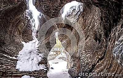 Close-up shot of cave stones partly covered in snow Stock Photo