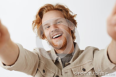 Close-up shot of charming friendly and carefree happy redhead guy with stylish wavy hairstyle and beard tilting from joy Stock Photo