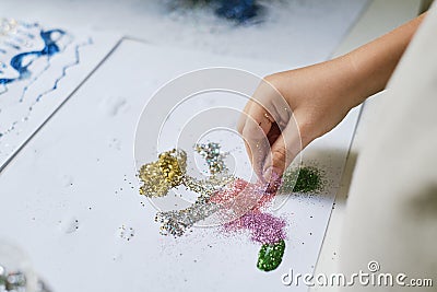 Hand creating funny art work with glitter Stock Photo