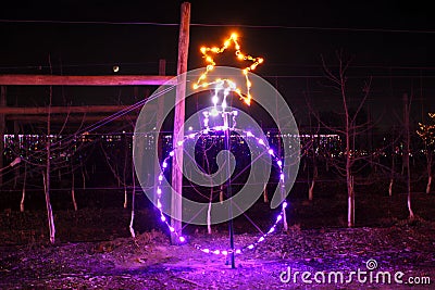 Close-up shot of a Christmas decoration ball shape with neon lights during the holiday show Editorial Stock Photo