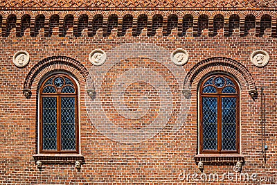 Close-up shot of cross hatch styled windows on a brick building in Krakow, Poland Stock Photo