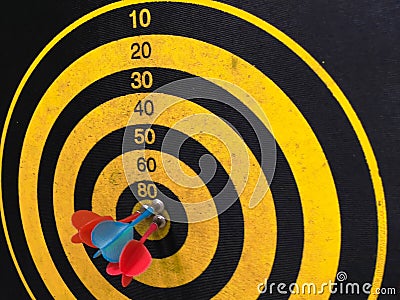 Close up shot of a dart board. Darts arrow Missing the target on a dart board during the game. Darts yellow Stock Photo