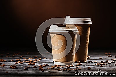 close-up shot of disposable cups on rustic wooden table spilled Stock Photo