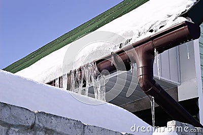 Close-up shot of a eavestrough at a standard roof. winter Stock Photo