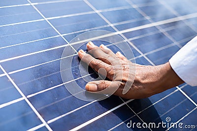 Close up shot of farmer hands feels newly installed solar panel for power generation - concept of new beginning Stock Photo