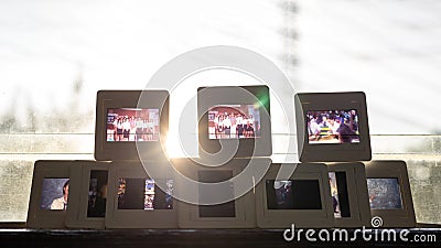 A close-up shot of film slides laid out in rows against the early morning sunlight Stock Photo