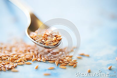 close-up shot of golden flaxseeds on a spoon Stock Photo