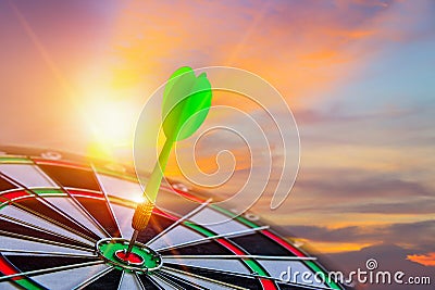 Close up shot green darts arrow on center for dartboard. Stock Photo