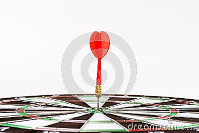 Close up shot green and red darts arrows in the target center. Stock Photo