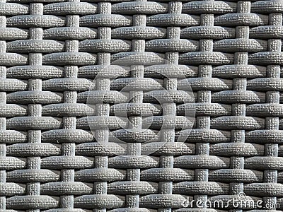 Close-up shot of the grey plastic rattan weaving of a outdoor furniture in sunlight Stock Photo