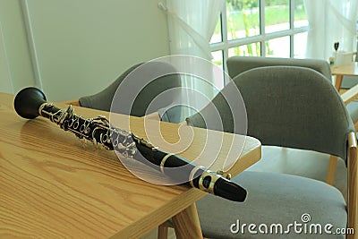 Close-up shot of a jazz clarinet instrument on a wooden table Stock Photo