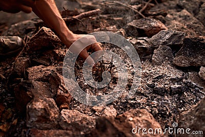 Close up shot of male hands making camp fire at sunset Stock Photo