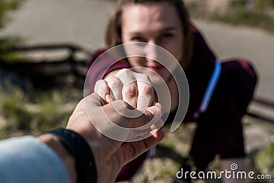 close-up shot of man giving helping hand to young woman Stock Photo