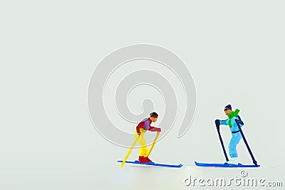 Close-up shot of miniature figurines of skiers isolated on a white background Stock Photo