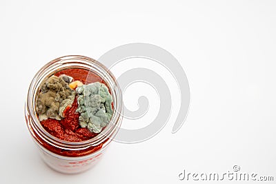 Close up shot of mouldy tomato paste in a jar isolated on white background with copy space Stock Photo