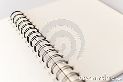 Close up shot of an open blank sketchbook placed on a light gray table. Stock Photo