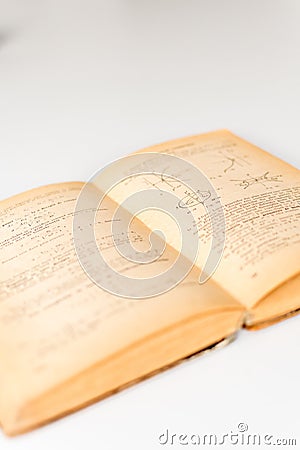 Close up shot of an open old science book containing equations and graphs from different fields: math, physics, chemistry. The Stock Photo