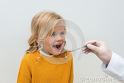 close-up shot of pediatrist giving mixture to smiling Stock Photo