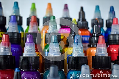 Close-up shot of rows of colorful tattoo inks in plastic bottles Stock Photo