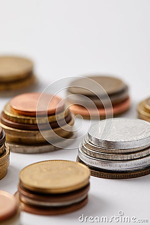 close-up shot of stacks of various coins on white Stock Photo