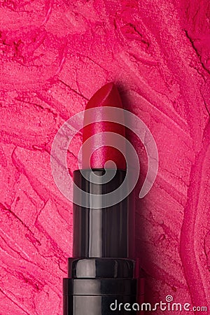 Close-up shot of stroke lipstick on a pink smudged lipstick background Stock Photo