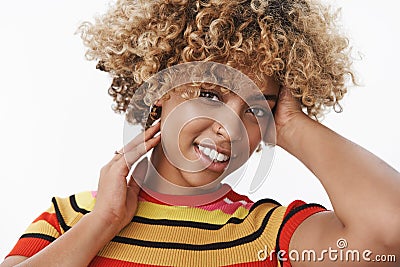 Close-up shot of tender and sensual attractive gentle african american stylish woman with fair afro haircut and pierced Stock Photo