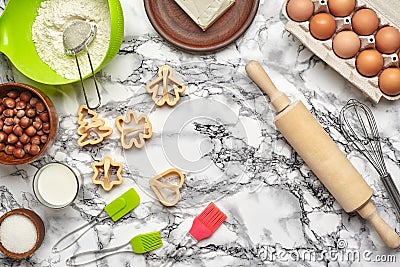 Close-up shot. Top view of a baking ingredients and kitchenware on the marble table background. Stock Photo