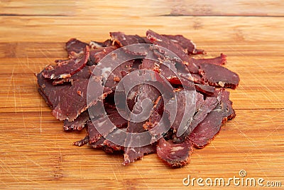 Close up shot of the Turkish traditional pastirma pastrami on wooden chopping board with copy space for text Stock Photo