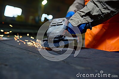 Steel Plant Worker Using Angle Grinder Stock Photo