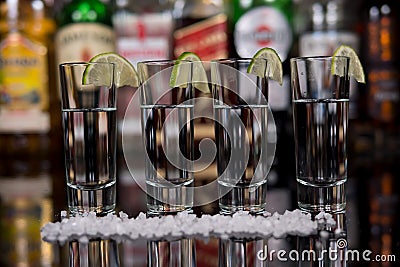 Close-up of a shots of tequila with lime and salt in a bar. Editorial Stock Photo