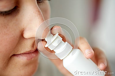 Close up of sick woman using nasal spray Stock Photo