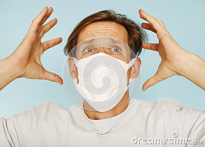Close up sick young man handsome wearing medical mask and white shirt isolated on blue background. Concept of sickness Stock Photo