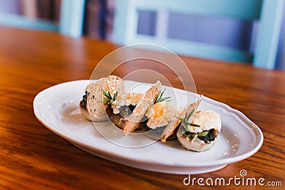 The close-up side photo of the food composition consisted of the mushrooms, cheese and dried bread. Stock Photo