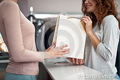 Close up of young lady holding purchase packet Stock Photo