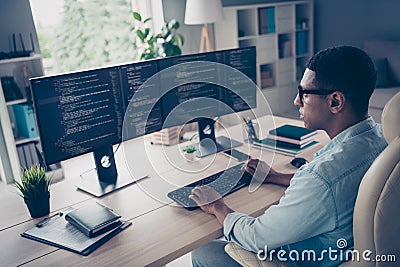 Close up side profile photo of professional young guy it specialist create code looking two modern monitors typing Stock Photo