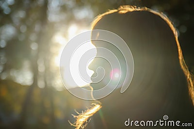 Close-up silhouette side view of woman looking at sunset. Mental health, hope, happiness concept. Dream autumn. Peace lifestyle. Stock Photo