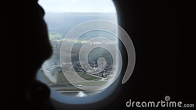 Close-up silhouette of traveler man watching beautiful aerial landscape view from plane window seat during the flight. Beautiful atmospheric shot, concept of stock video Close-up silhouette of traveler man watching beautiful aerial landscape view from plane window seat during the flight. Beautiful atmospheric shot, concept of stock video
