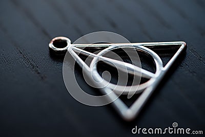 Close up silver necklace focus deathly hallows Stock Photo