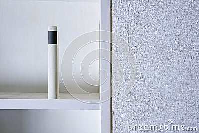 Close up of single book upright in white shelf Stock Photo