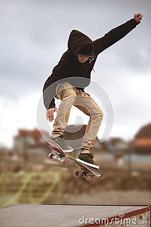 Close up of a skateboarders feet while skating active performance of stunt teenager shot in the air on a skateboard in a Stock Photo