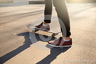 Close-up of skateboarders feet while skating in skate park. Man riding on skateboard. view, low angle shot. Stock Photo