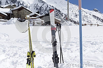 Close up of skis in the snow with background blue sky and the ski slope Stock Photo