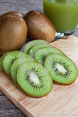 Close up sliced kiwi and kiwi juice on wood booard Stock Photo