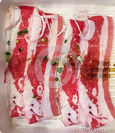 Close up. Slide raw wagyu beef on a red and white plate. uncooked beef, Japanese style for meat grill. Stock Photo
